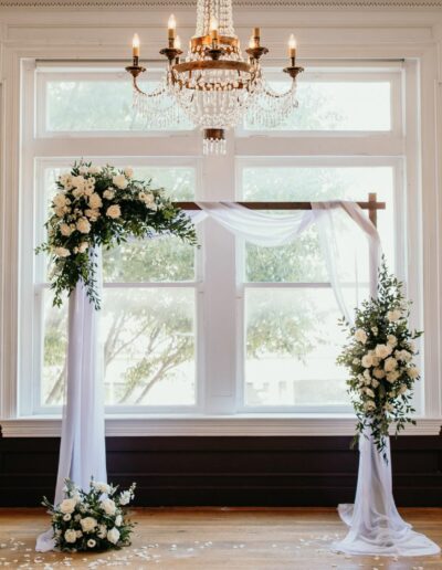 Ceremony Arch with white draping and white and green florals