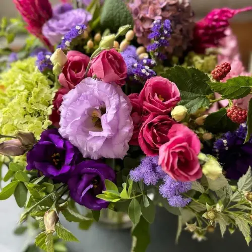 Up close view of purple, red and green florals in an arrangement