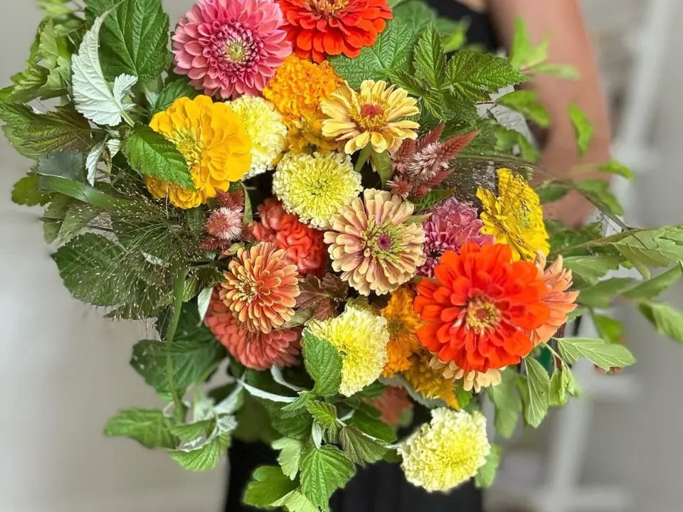 Seasonal bouquet with orange, yellow and greenery