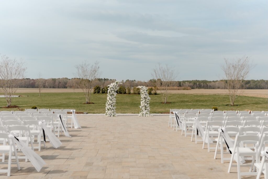 Two white and greenery pillars for ceremony at Breckenridge Barn by Winters Farm Florals