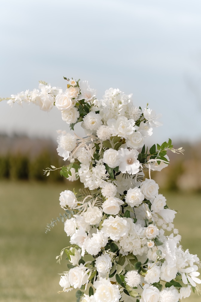 White pillar ceremony florals up close by Winters Farm Florals