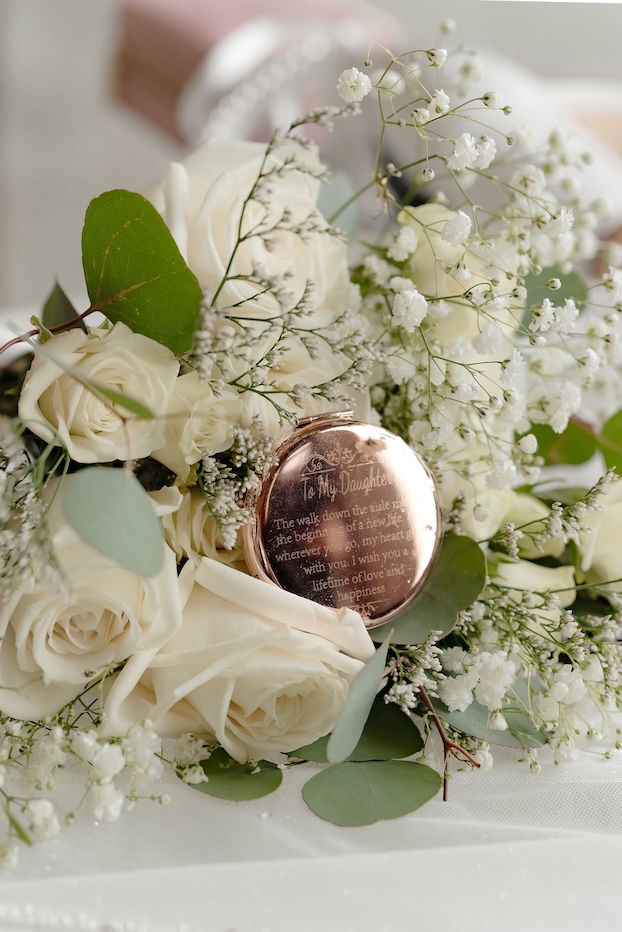 A locket close up with white and green florals by Winters Farm Florals