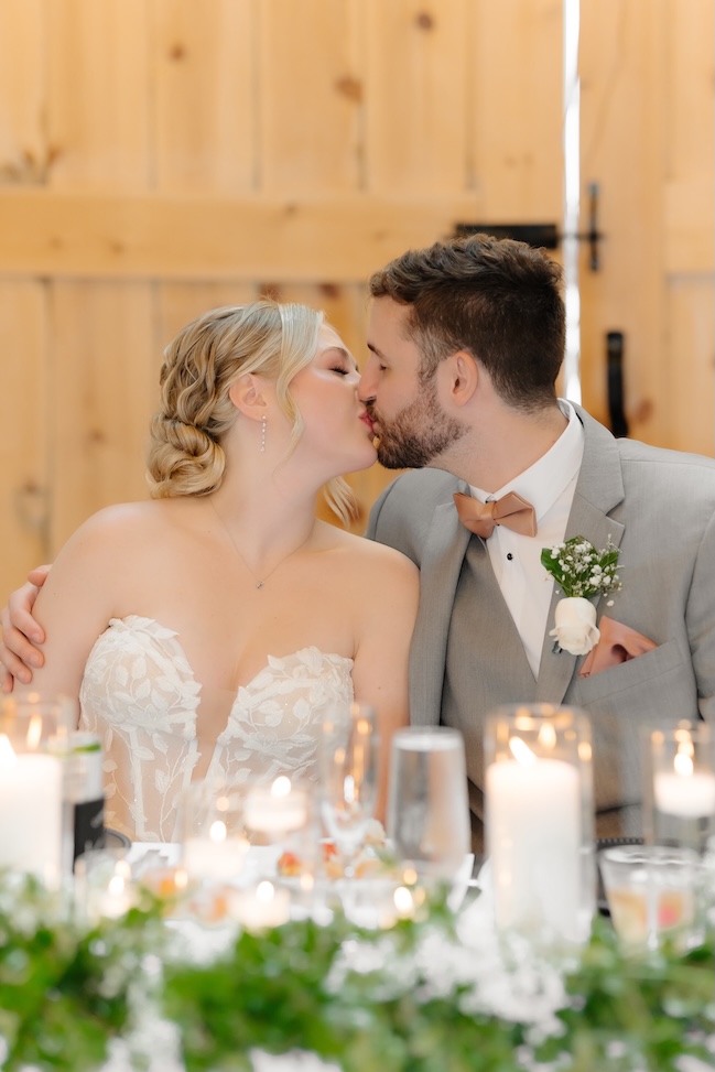 Bride and groom kissing at their reception at Breckenridge Barn